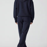 Rear view of an oversized navy hoodie for women showing the hood and fit
