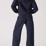 A back view of a navy hoodie womens style paired with matching trousers