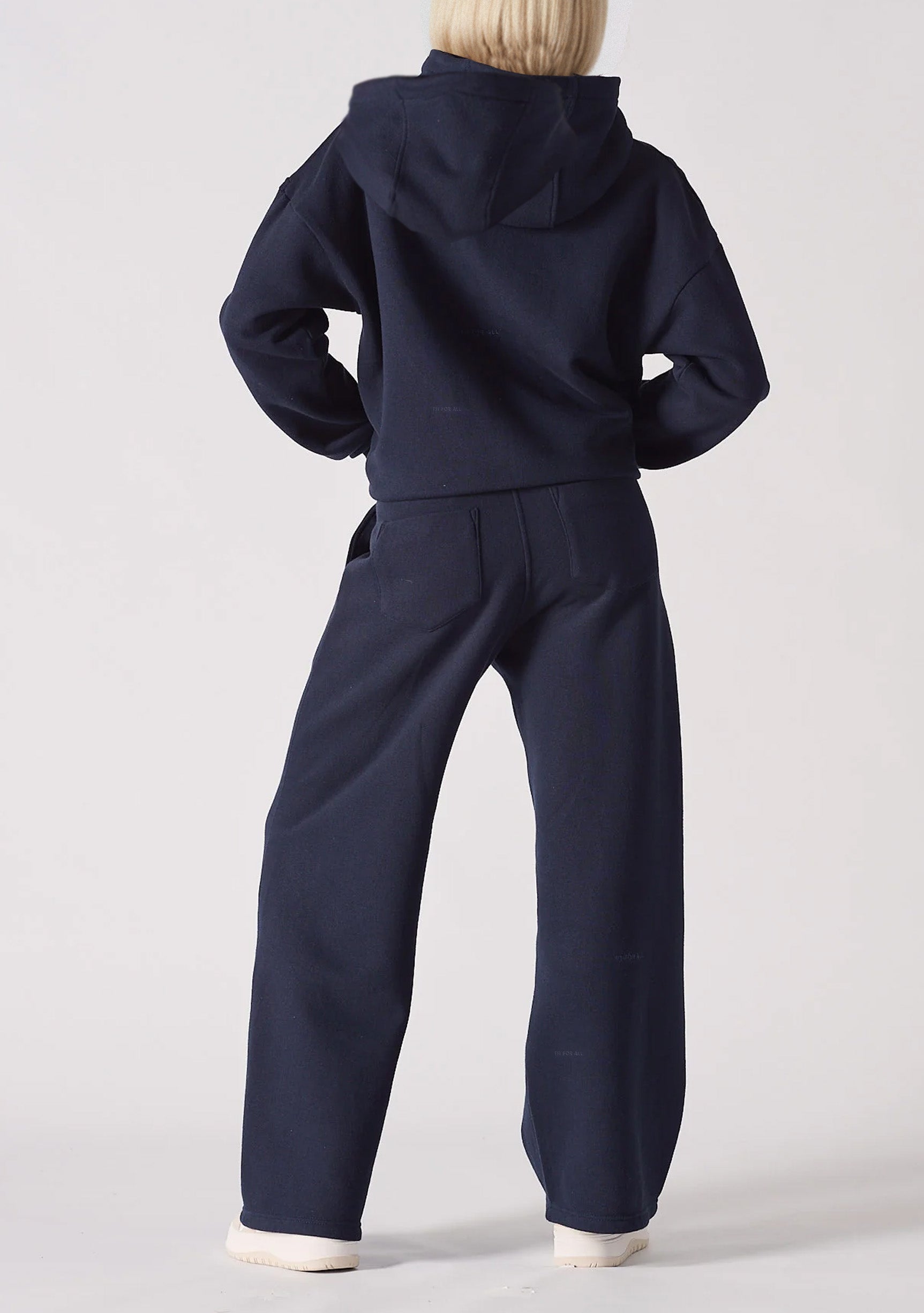 A back view of a navy hoodie womens style paired with matching trousers