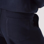 Close up detail of the soft fabric and pocket on the navy wide leg joggers