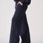 Side profile view of navy wide leg joggers showing the side pocket