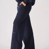 Side profile view of navy wide leg joggers showing the side pocket