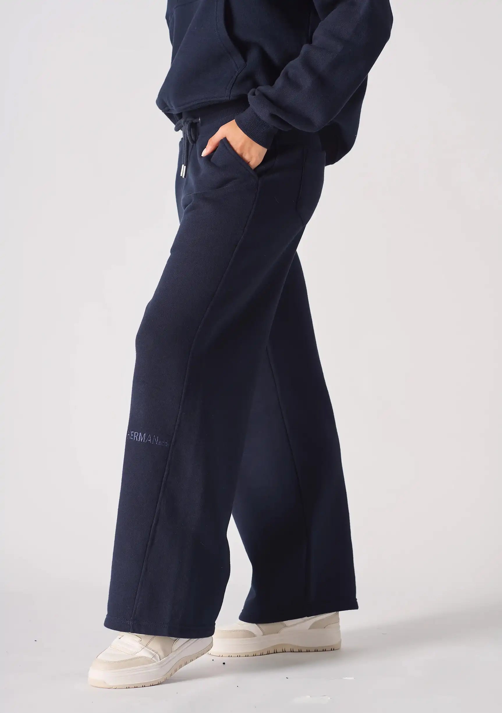 Side profile view of navy wide leg joggers showing the side pocket