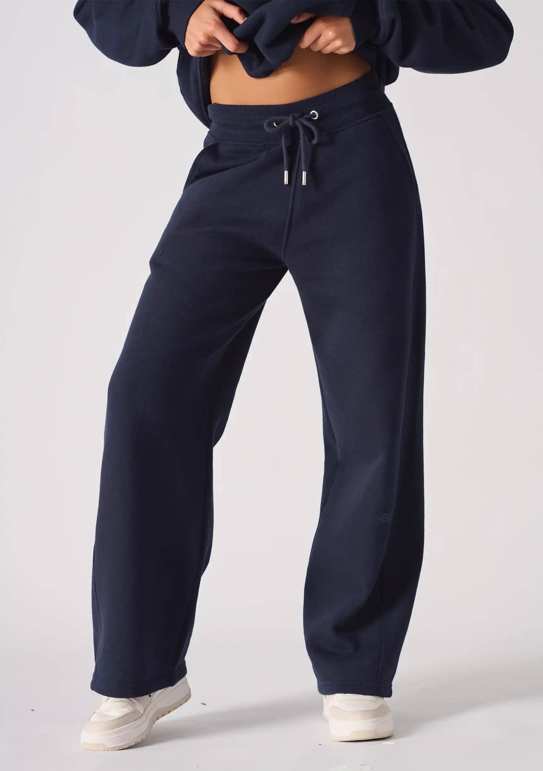 Front view of the waistband and drawstring on these navy wide leg joggers