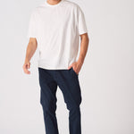 Man walking in navy blue chinos slim fit for a smart casual look.