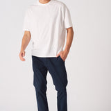Man walking in navy blue chinos slim fit for a smart casual look.