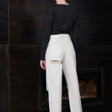 Back view of a model in the off-white distressed jeans for women.