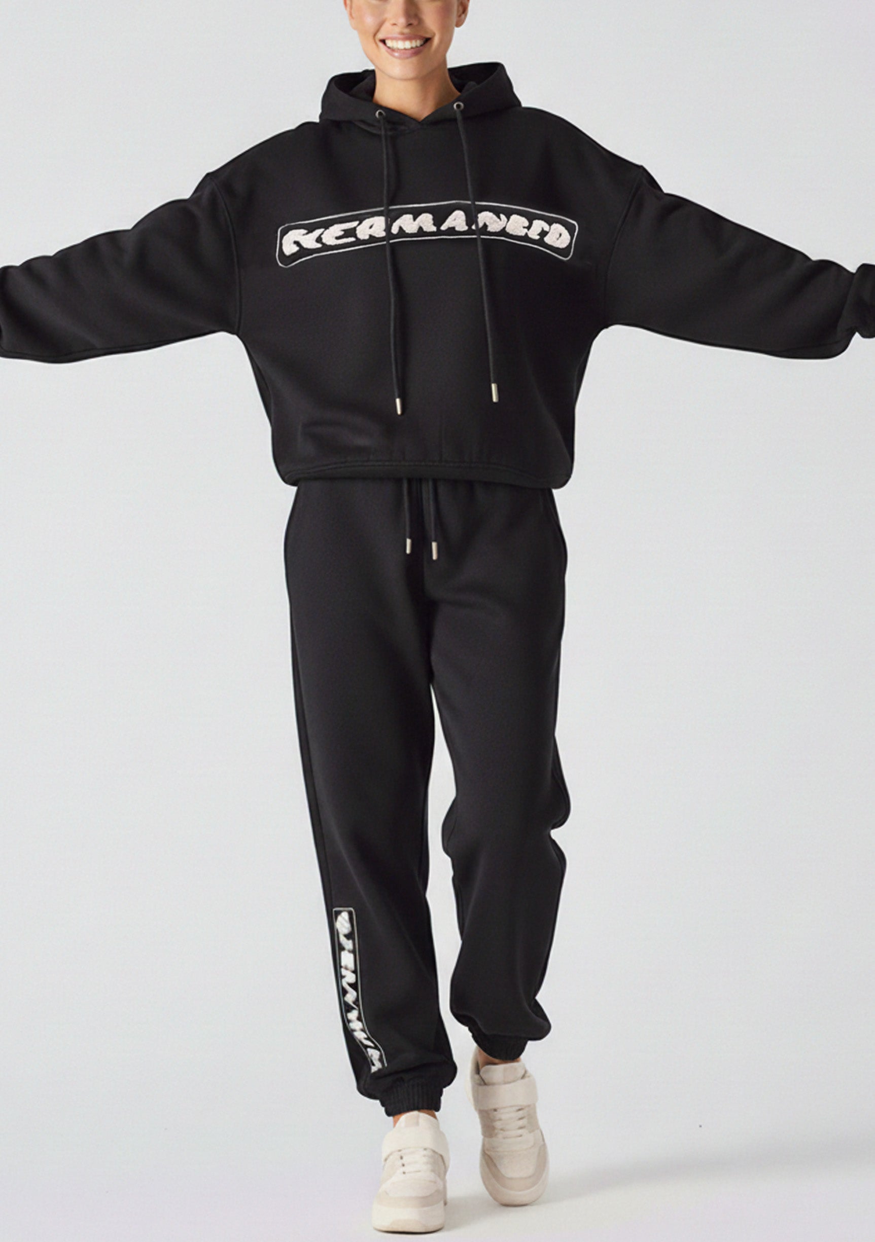 Model posing in the oversized hoodie black for a classic UK street style look.