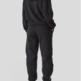 Rear view of a model wearing a comfortable oversized hoodie black.
