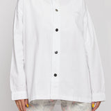 Oversized white shirt collar and logo close up