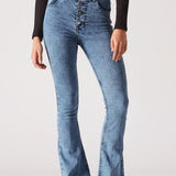 Person wearing blue flared jeans on a white background