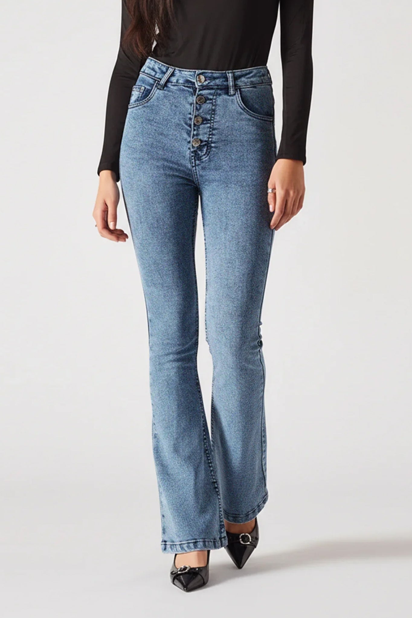 Light blue jeans worn by a person on a white background