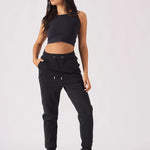 Full length view of model wearing black pintuck jogger and crop top