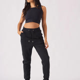 Full length view of model wearing black pintuck jogger and crop top