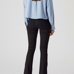 Full back view of model wearing charcoal grey high-waisted bootcut jeans featuring a clean back with no pockets.