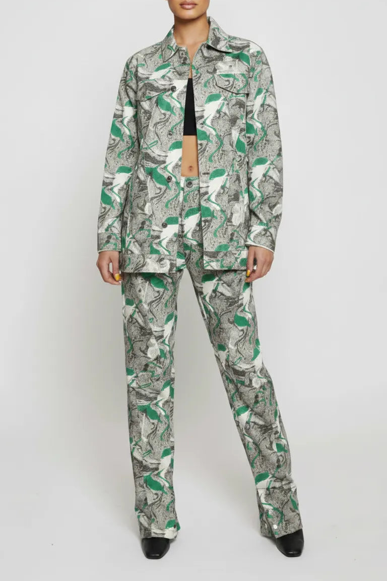 Front full length of psychedelic print denim jacket worn open over black crop top - women’s matching abstract swirl cargo pants set with pointed toe boots