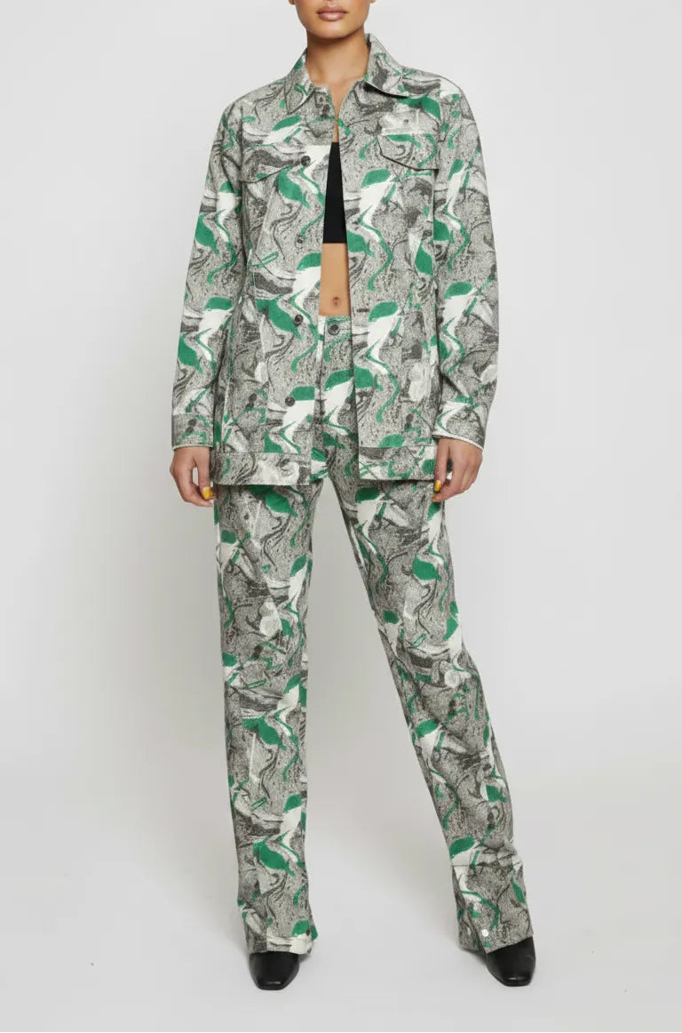 Front full length of psychedelic print denim jacket worn open over black crop top - women’s matching abstract swirl cargo pants set with pointed toe boots