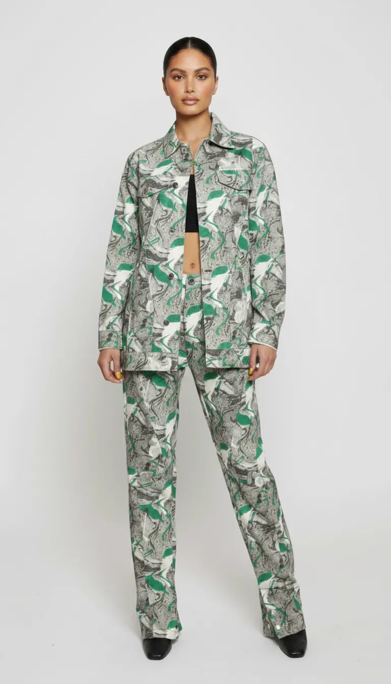 Front full length of psychedelic print denim jacket worn open over black crop top - women’s matching abstract swirl cargo pants set with pointed toe boots
