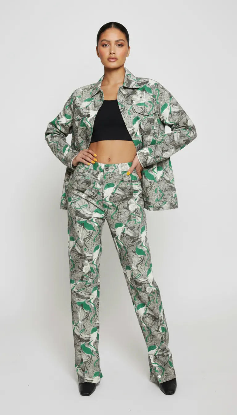 Front pose of psychedelic print denim jacket worn open over black crop top with hands on hips - women’s matching abstract swirl cargo pants set