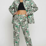 Front pose of psychedelic print denim jacket worn open over black crop top with hands on hips - women’s matching abstract swirl cargo pants set