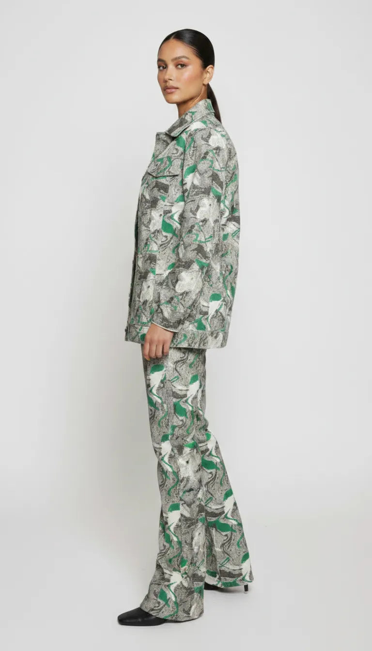 Side profile full length of psychedelic print denim jacket showing flared cargo pants silhouette - women’s green-grey abstract swirl two-piece set
