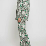 Side profile full length of psychedelic print denim jacket showing flared cargo pants silhouette - women’s green-grey abstract swirl two-piece set