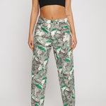 Close-up of the psychedelic printed jeans for women styled with a black crop top.