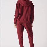 Back view of a model in the relaxed fit red zip up hoodie womens showing the hood.