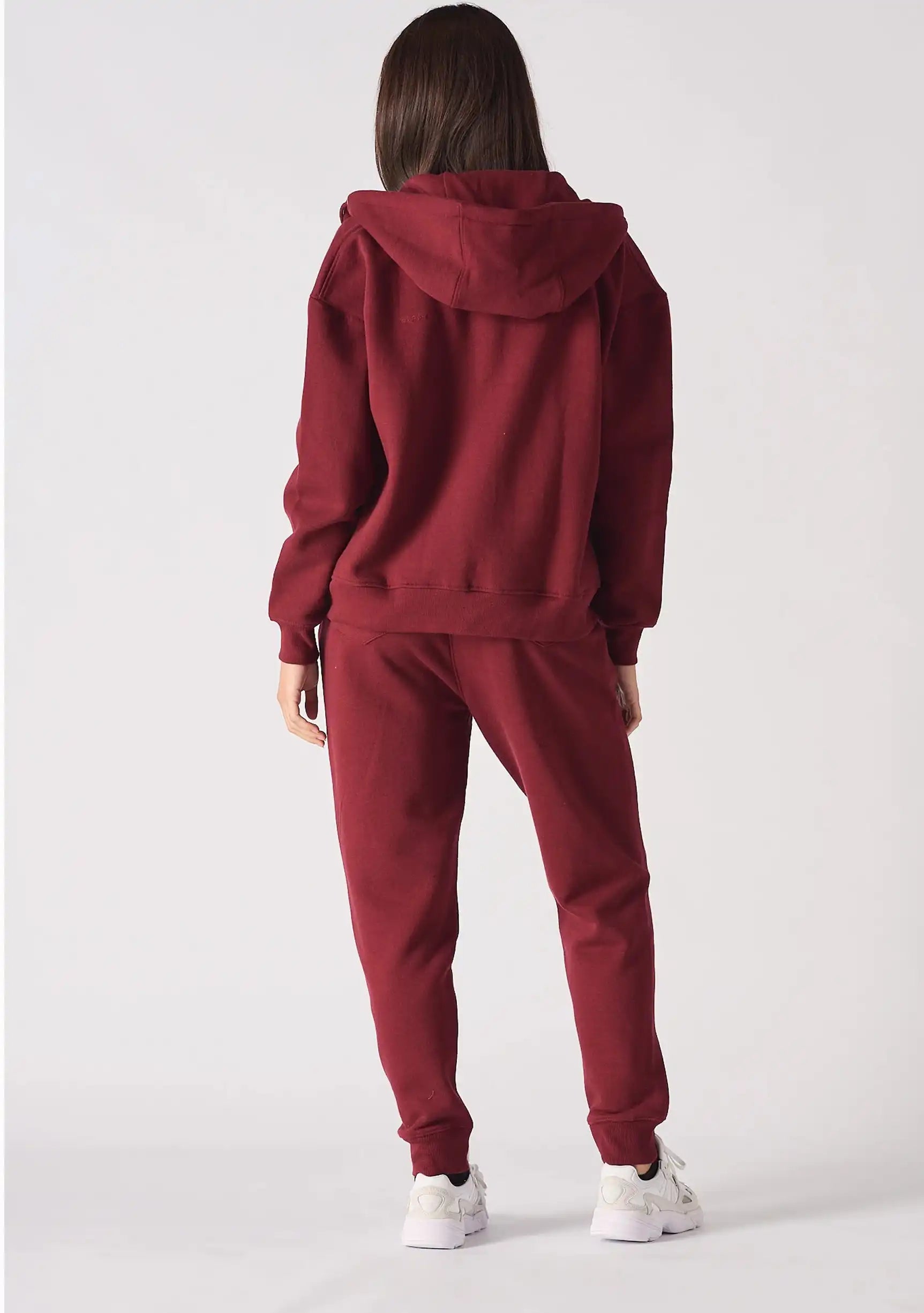 Back view of a model in the relaxed fit red zip up hoodie womens showing the hood.