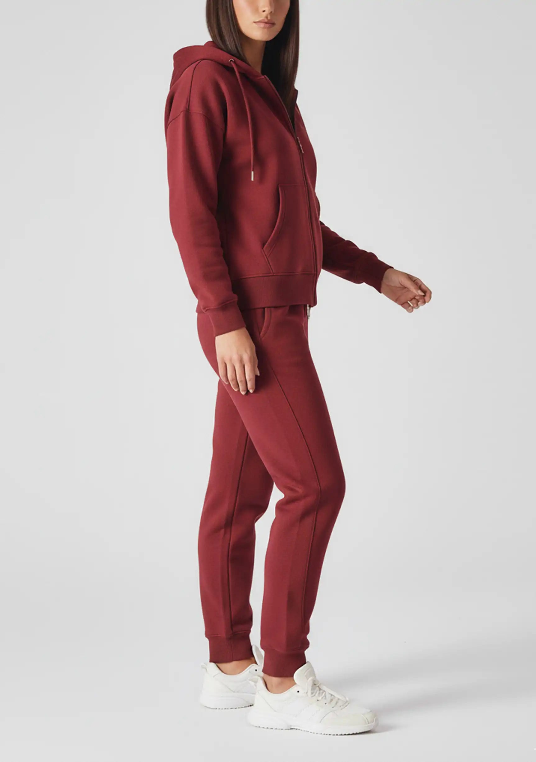 Side profile of a woman walking in the comfortable red zip up hoodie womens.