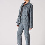 Side profile of speckle print denim jacket and cargo pants set - women's blue grey acid wash two-piece outfit with metallic platform heels