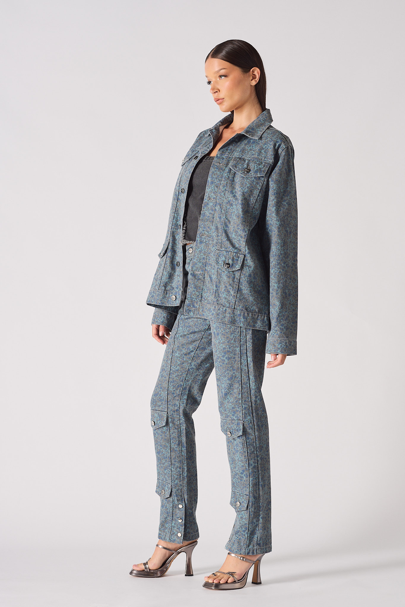 Side profile of speckle print denim jacket and cargo pants set - women's blue grey acid wash two-piece outfit with metallic platform heels