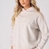 Front view of a model posing in a stone graphic hoodie with hands in pockets
