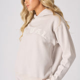 Side profile view of a model wearing a stone graphic hoodie with her hand to her face