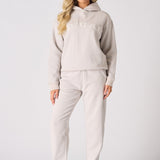 Full front length view of a model styling a stone graphic hoodie and joggers