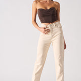 Woman wearing a strapless top and beige pants on a white background