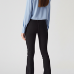 Angled back view of women's charcoal bootcut jeans showing the pocketless design and center back seams.