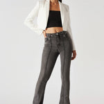 Studio shot of model standing straight in styled charcoal grey high-waisted bootcut jeans