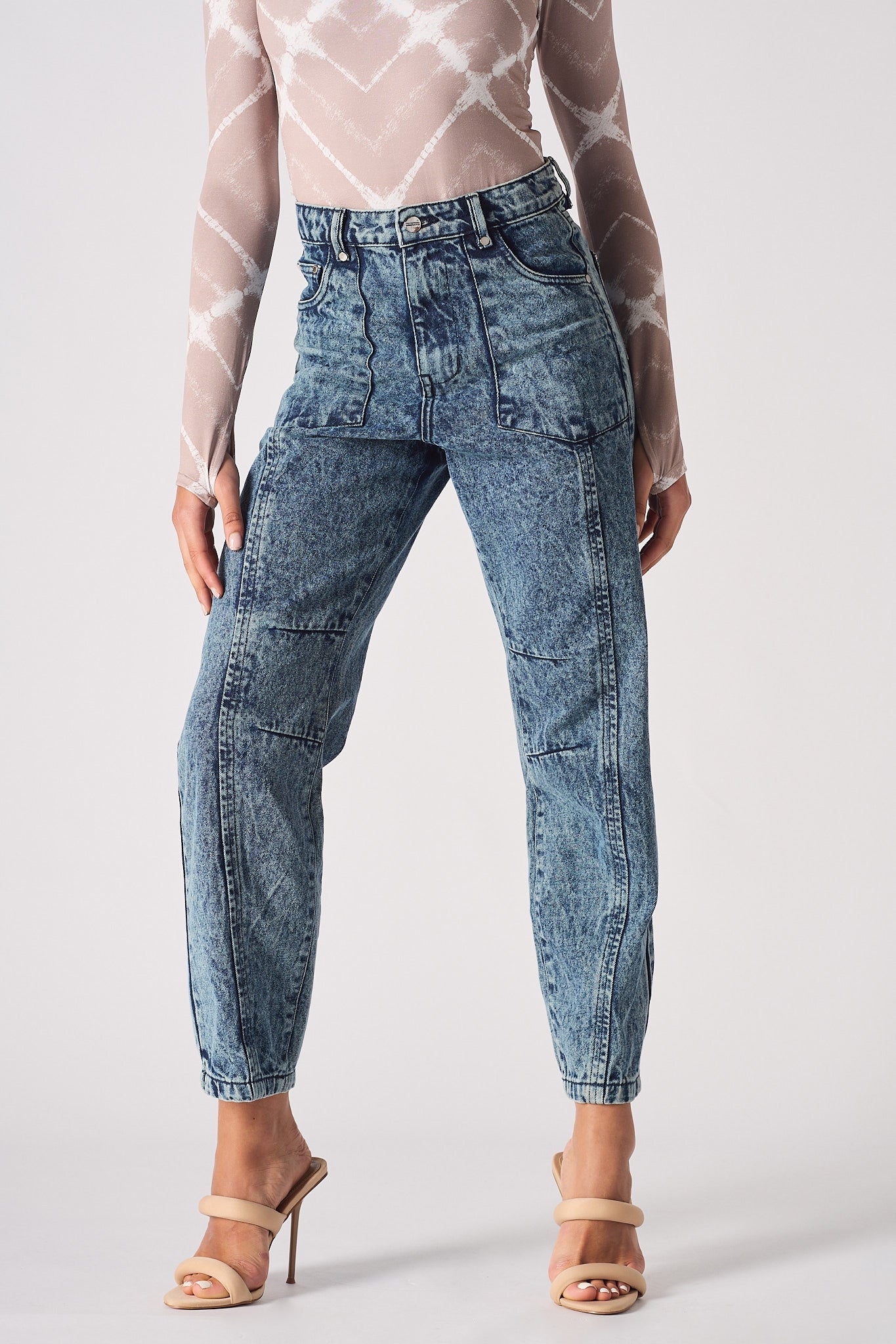 Close-up of the tapered acid wash mom jeans showing the front pockets and wash.