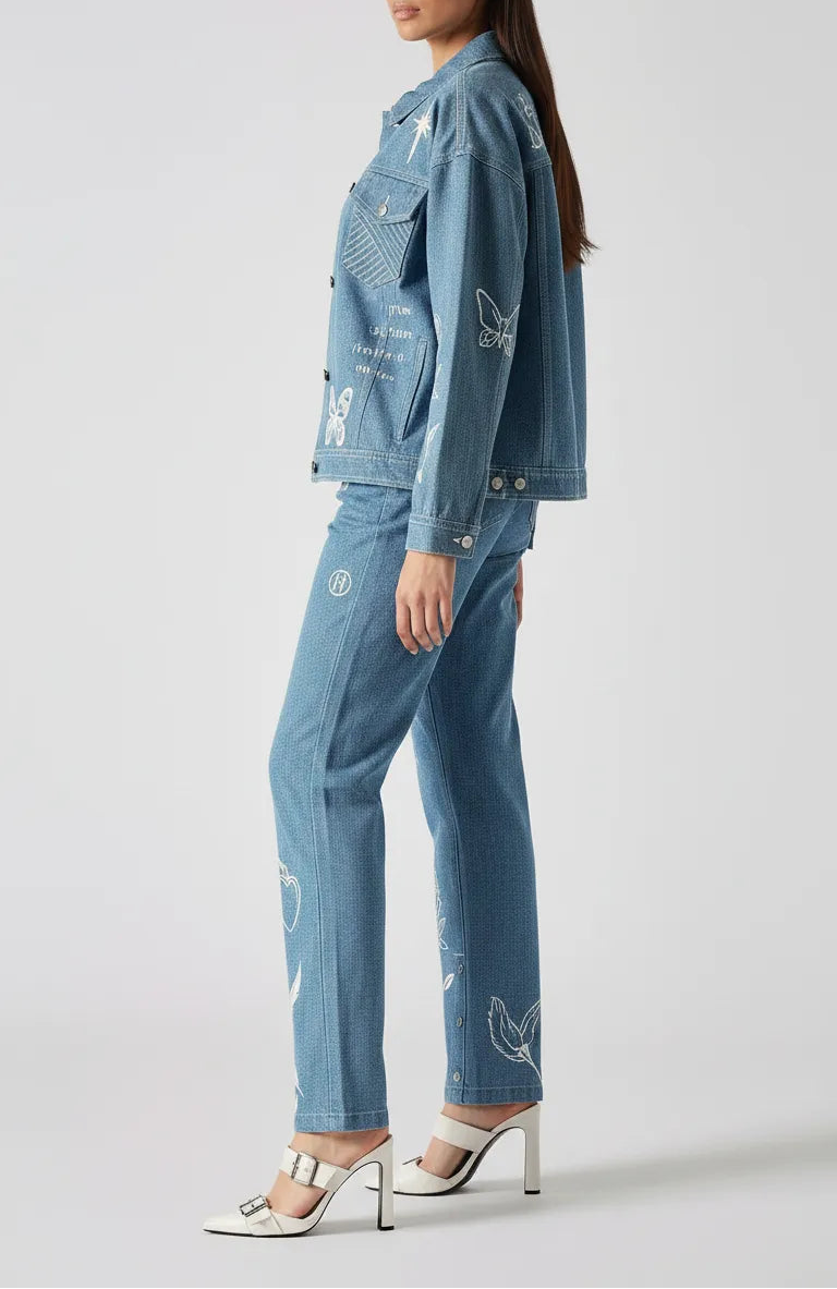 Back and side angle of mid wash tattoo print denim jacket showing sleeve and back embroidery - women’s oversized set with celestial and floral designs on cargo pants