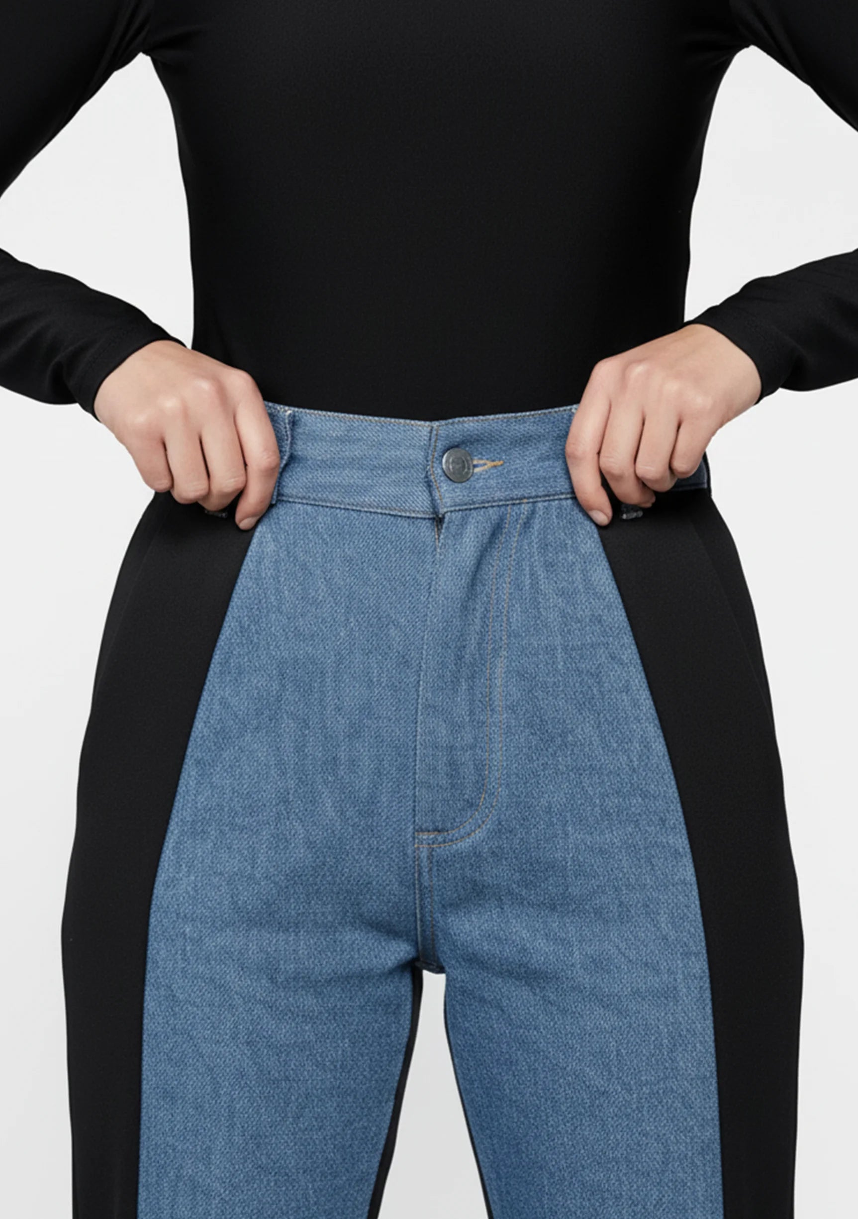 Close up of the waist fit and button closure on women's two-shade light blue and black jeans.