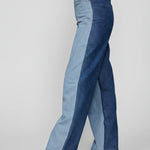 Side profile view of women's two-tone wide leg jeans showing light and dark blue denim