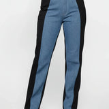 Person wearing black and blue pants on a white background
