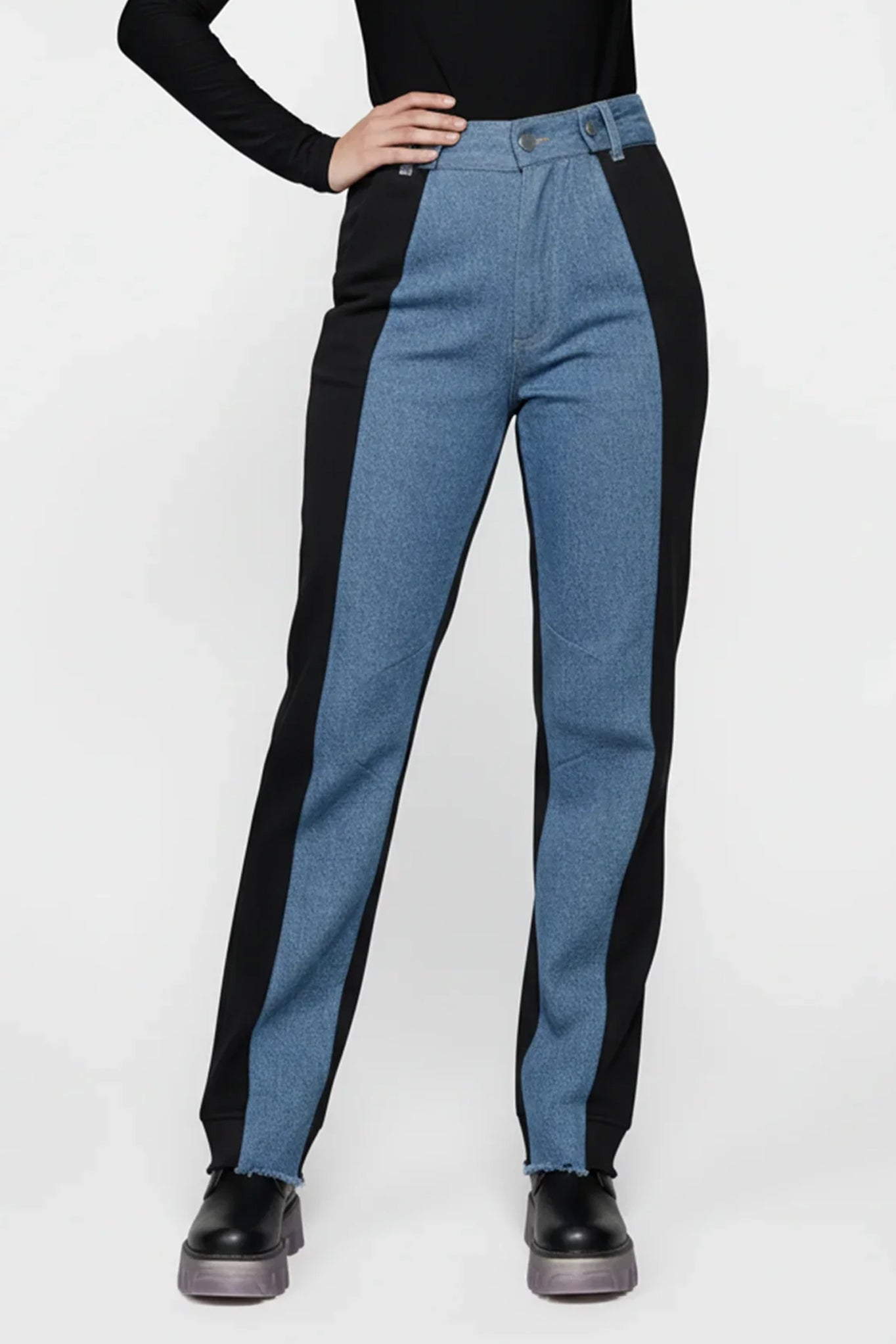 Person wearing black and blue pants on a white background