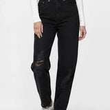 Person wearing black jeans and white sneakers on a white background