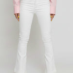 Close up of the front pockets, button closure, and high waist on white jeans