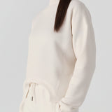 A woman walking while wearing a comfortable white cotton jumper