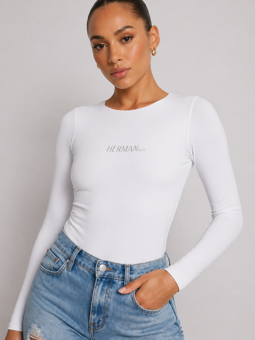 White crew neck bodysuit front close up showing logo
