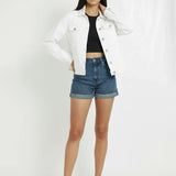 Front view of women's white denim trucker jacket styled with hand near collar - casual cotton jean jacket