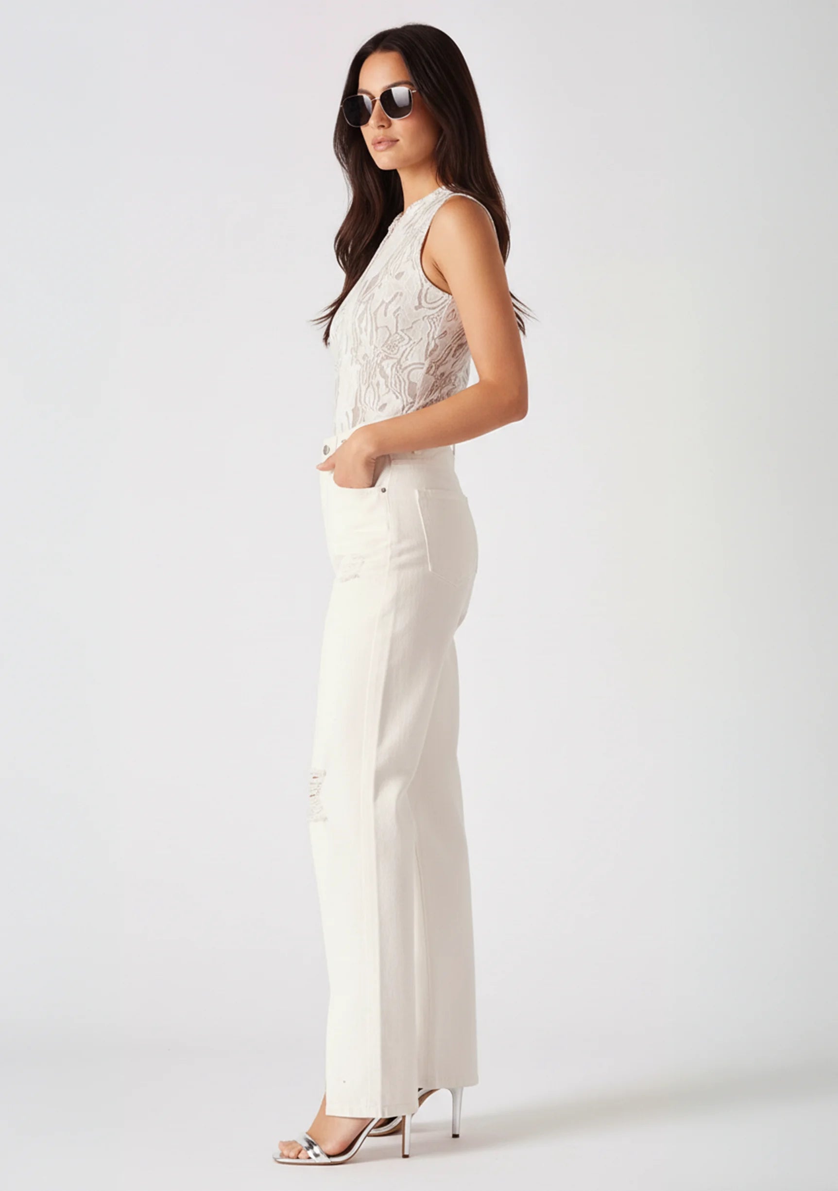 Static side profile view showing the straight cut and fit of white denim pants.